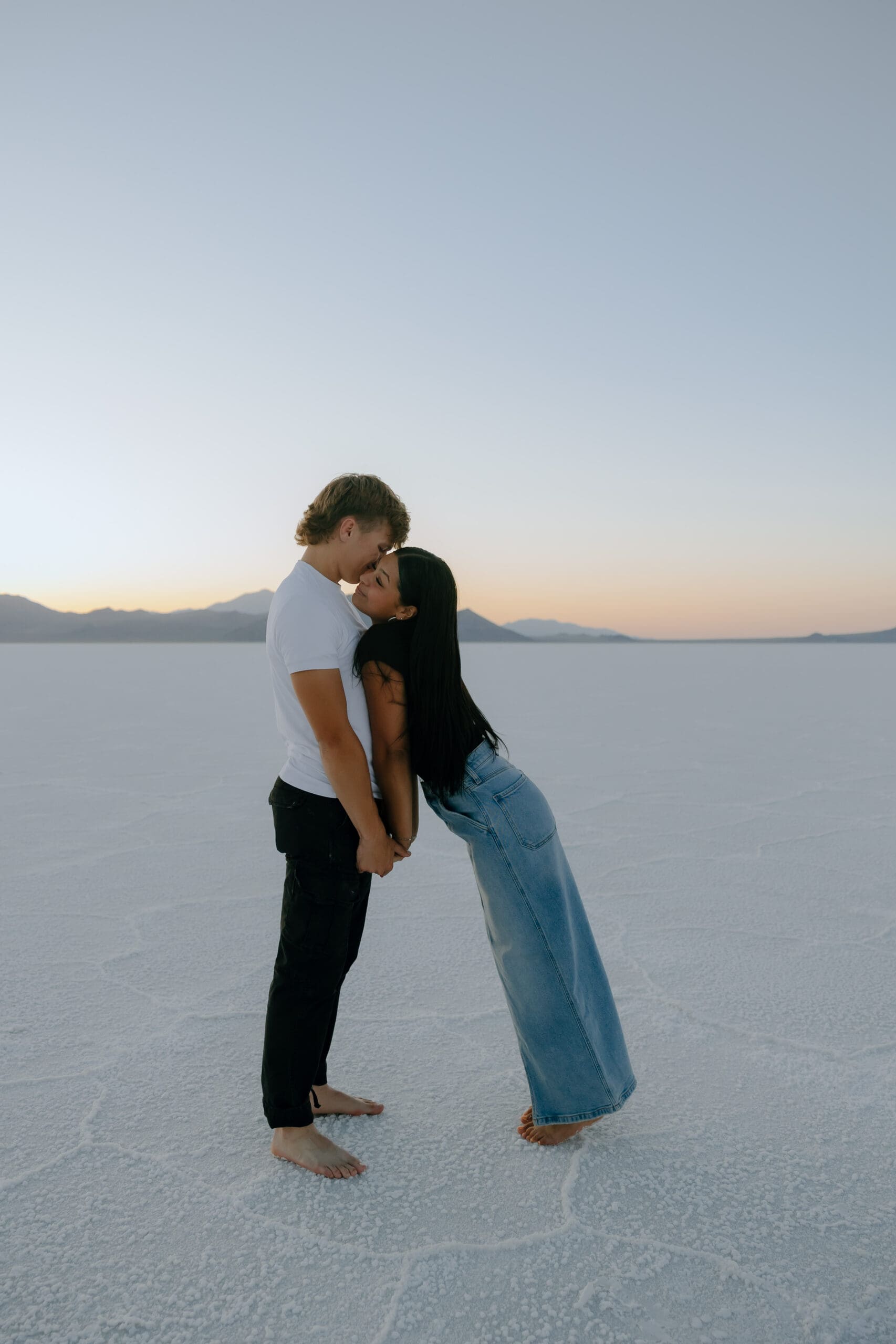 couple pose in the Salt Flats during their Southern Utah engagement photoshoot