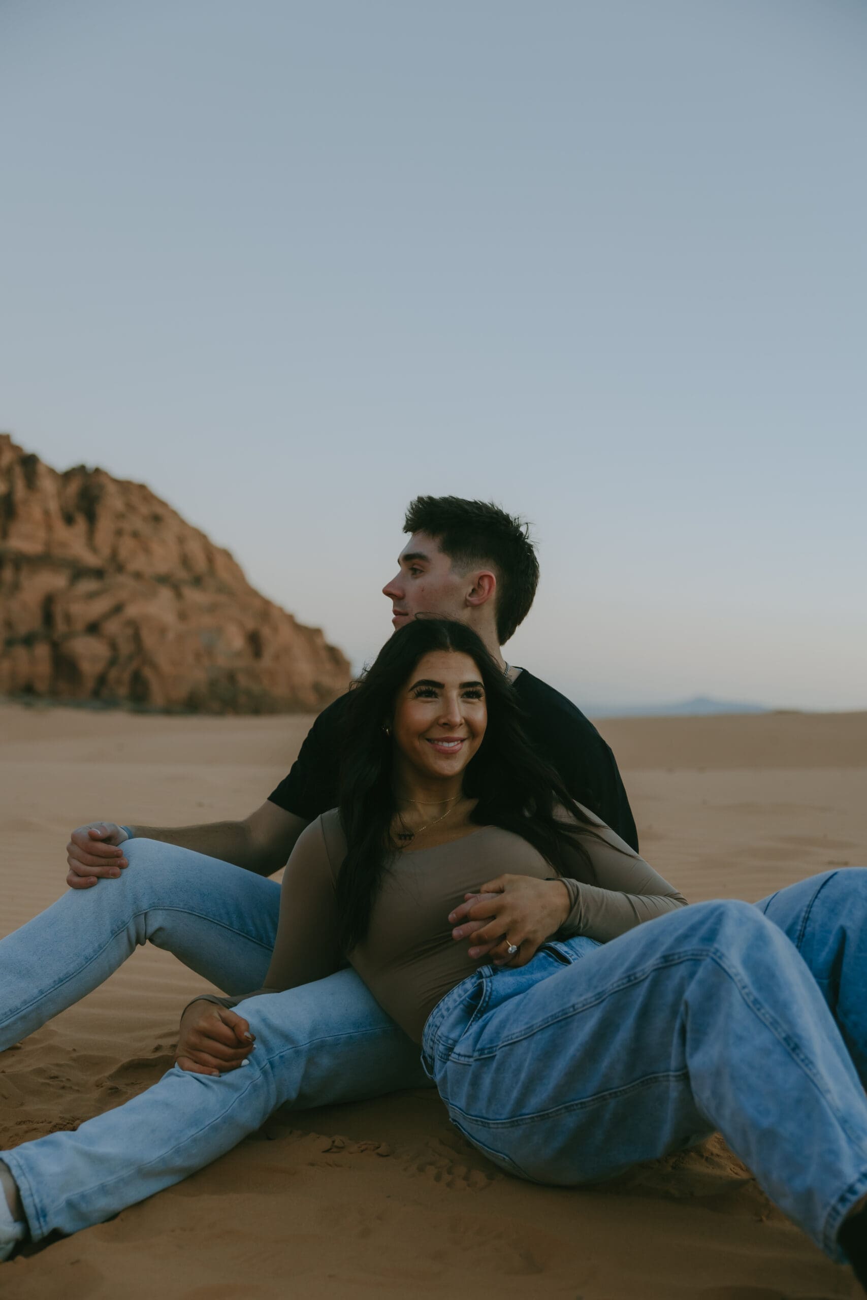stunning couple pose together in Utah desert together during their engagement photoshoot