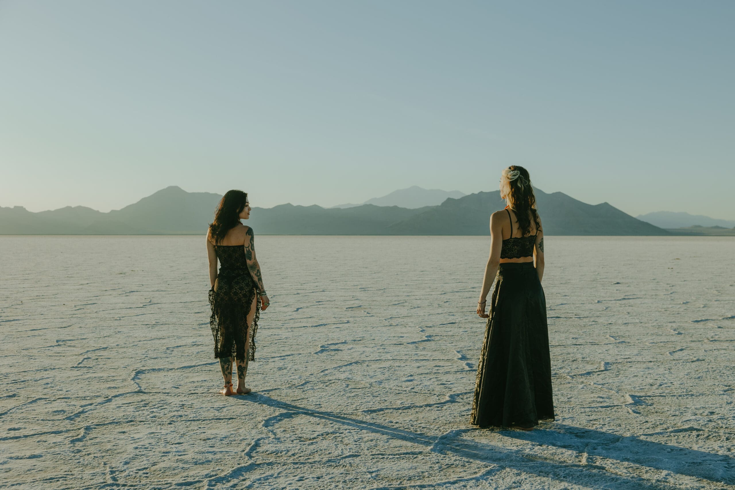 couple stand in the Salt Flats during their Southern Utah engagement photoshoot