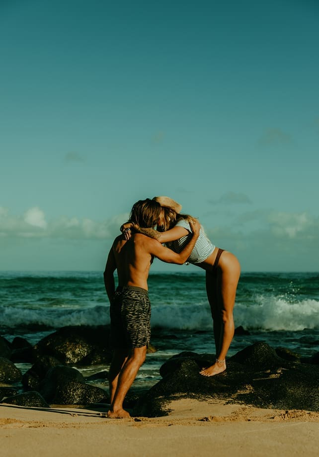 stunning couple share loving moments on the beach during their couples shoot