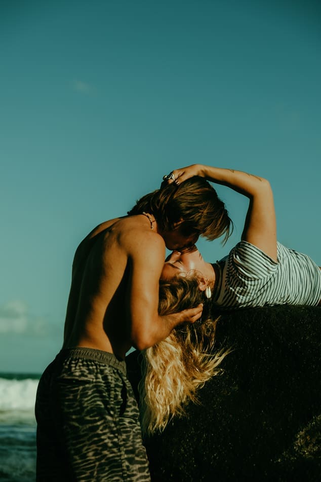 stunning couple share loving moments on the beach during their couples shoot