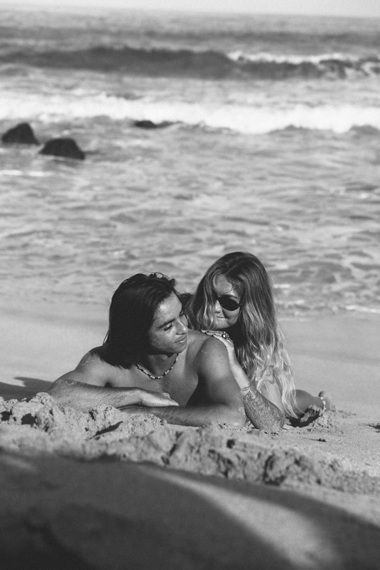 stunning couple share loving moments on the beach during their couples shoot