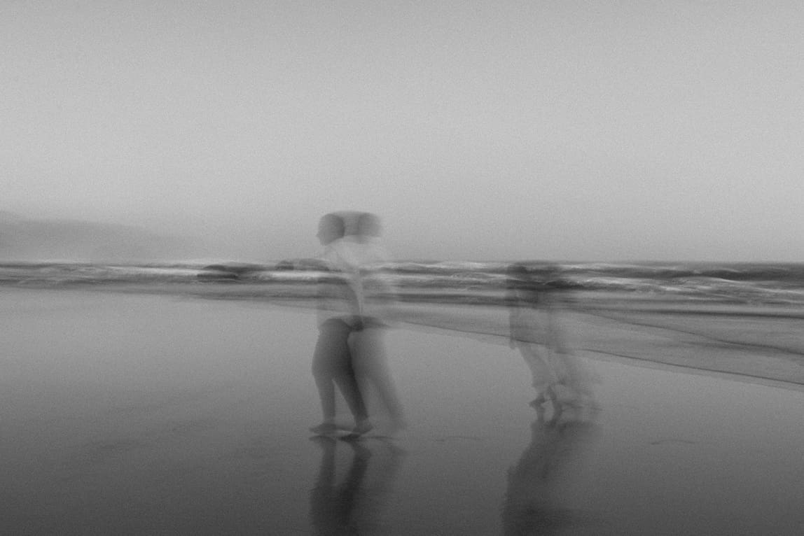 stunning couple share loving moments on the beach during their couples shoot