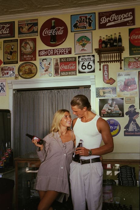 couple pose for photos together in a general store 