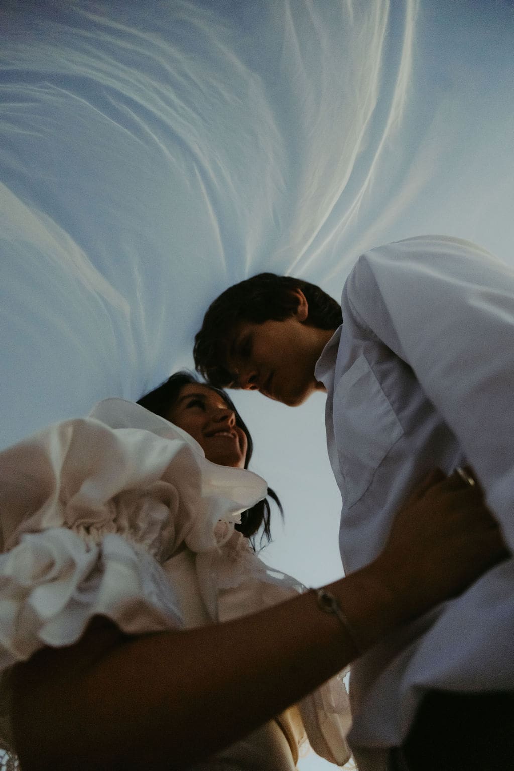 bride and groom pose under the blue skies