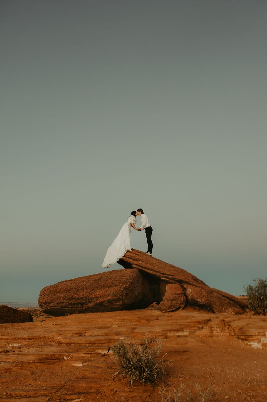 bride and groom pose on the overlook during their horseshoe bend elopement