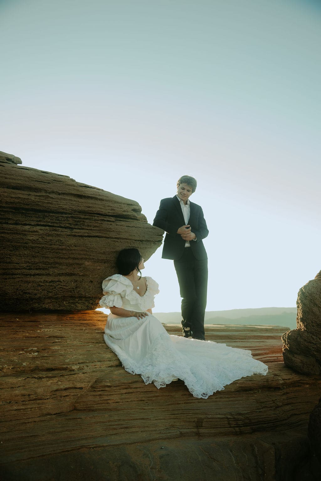 bride and groom pose on the overlook during their horseshoe bend elopement