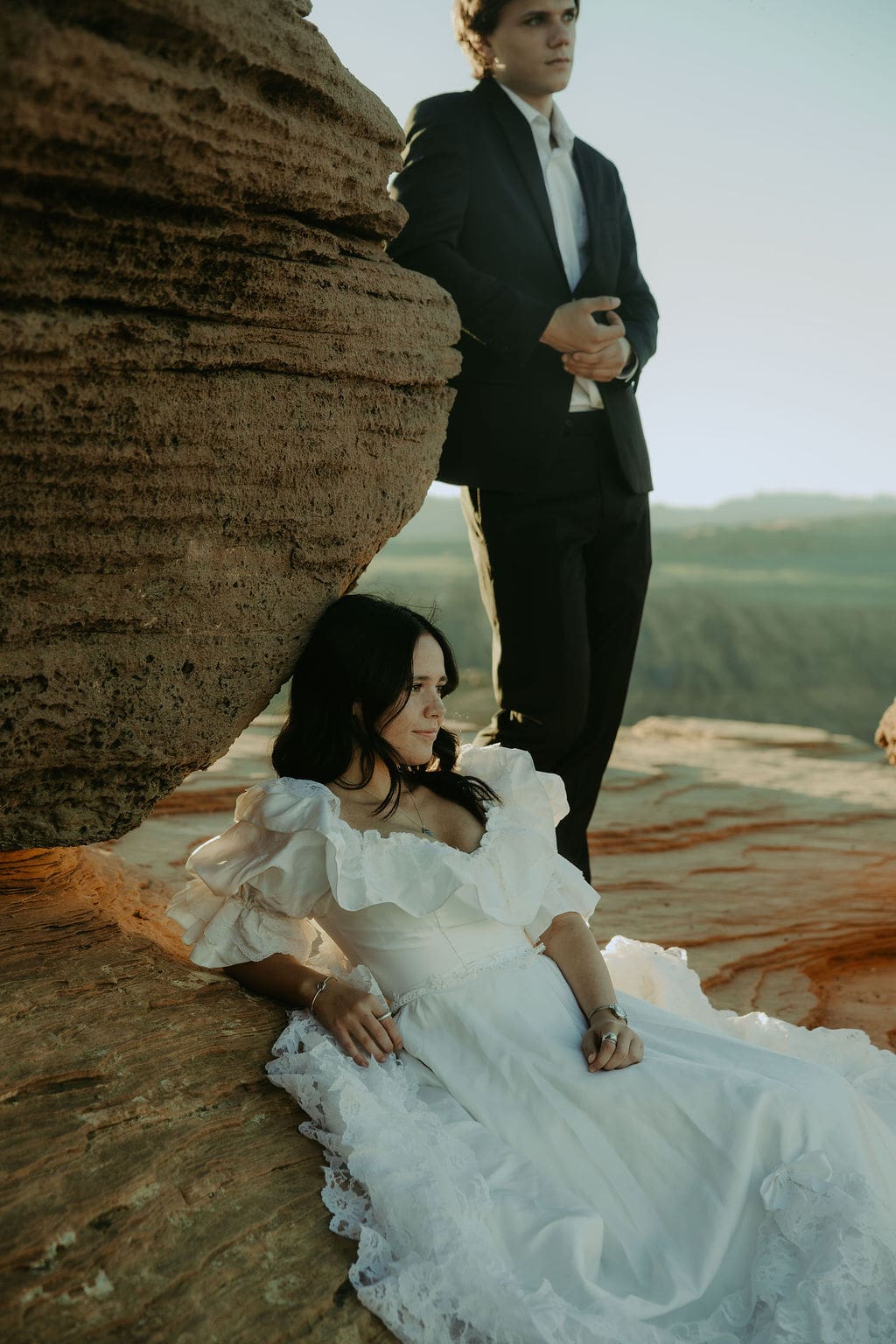 bride and groom pose on the rocks of the Arizona nature