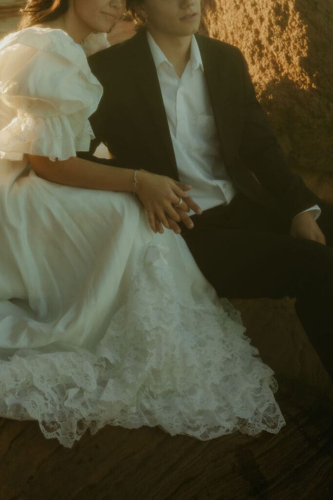 bride and groom pose on the rocks of the Arizona nature