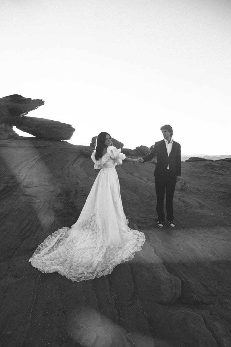 stunning bride looks over her shoulder while her grow admires his new wife