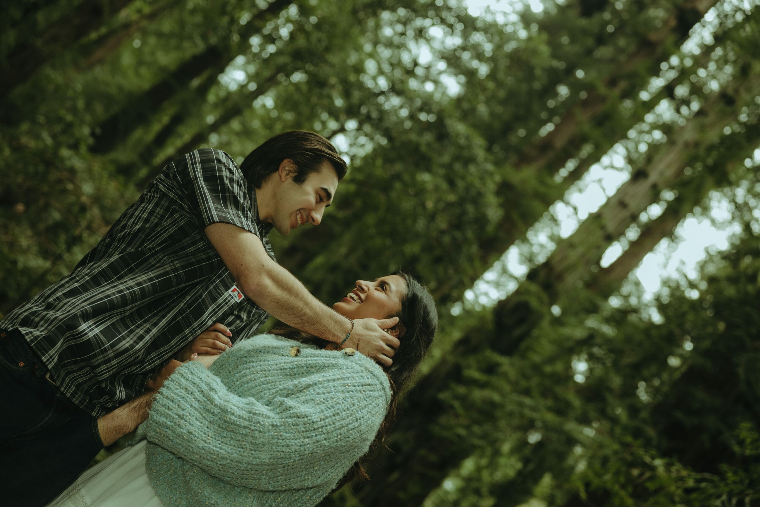 couple share a moment in the forest