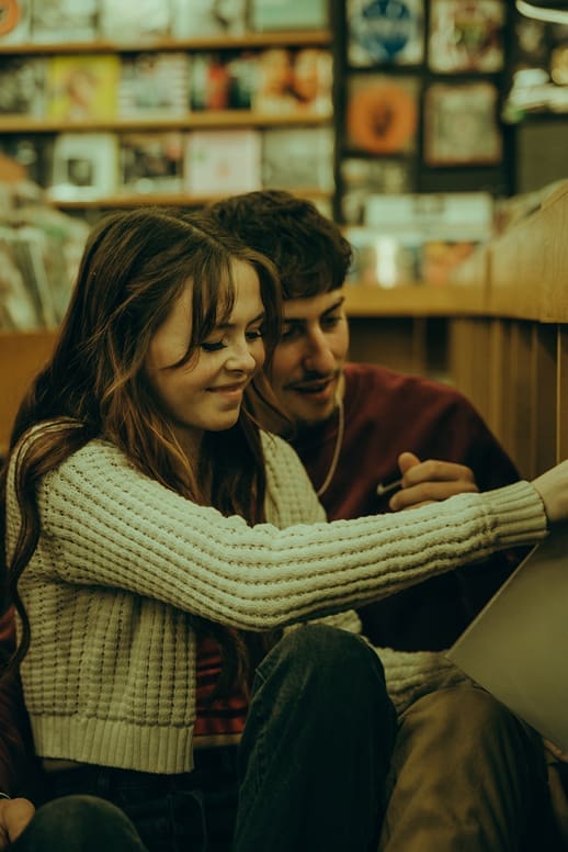 documentary style couples photos from a record store photoshoot 