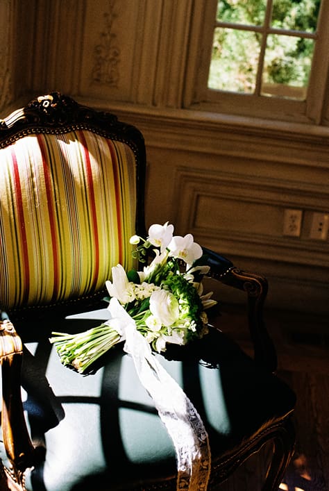 brides bouquet lies on the classy chair