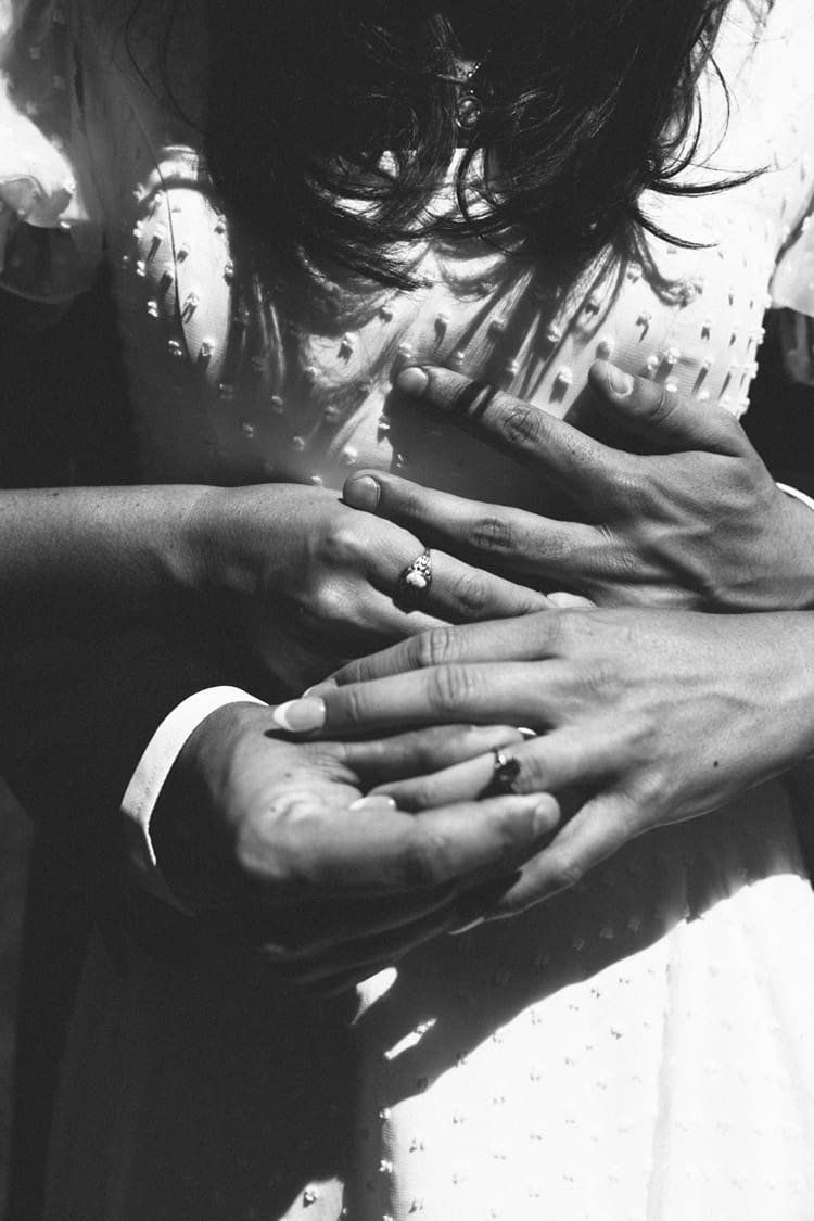 bride and groom showcase their new rings